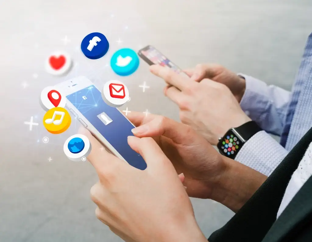 Close-up of two people holding smartphones with floating social media icons, representing digital communication.