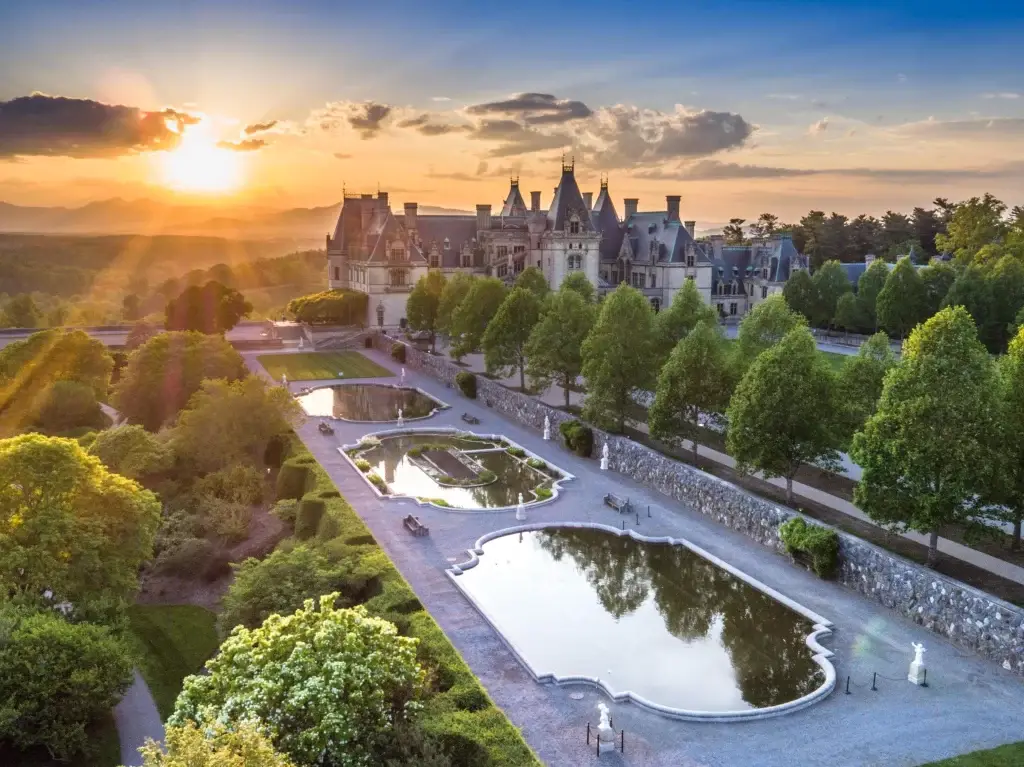 The stunning Biltmore Estate, with its gardens and reflecting pools, at sunset. Website Design Asheville NC.