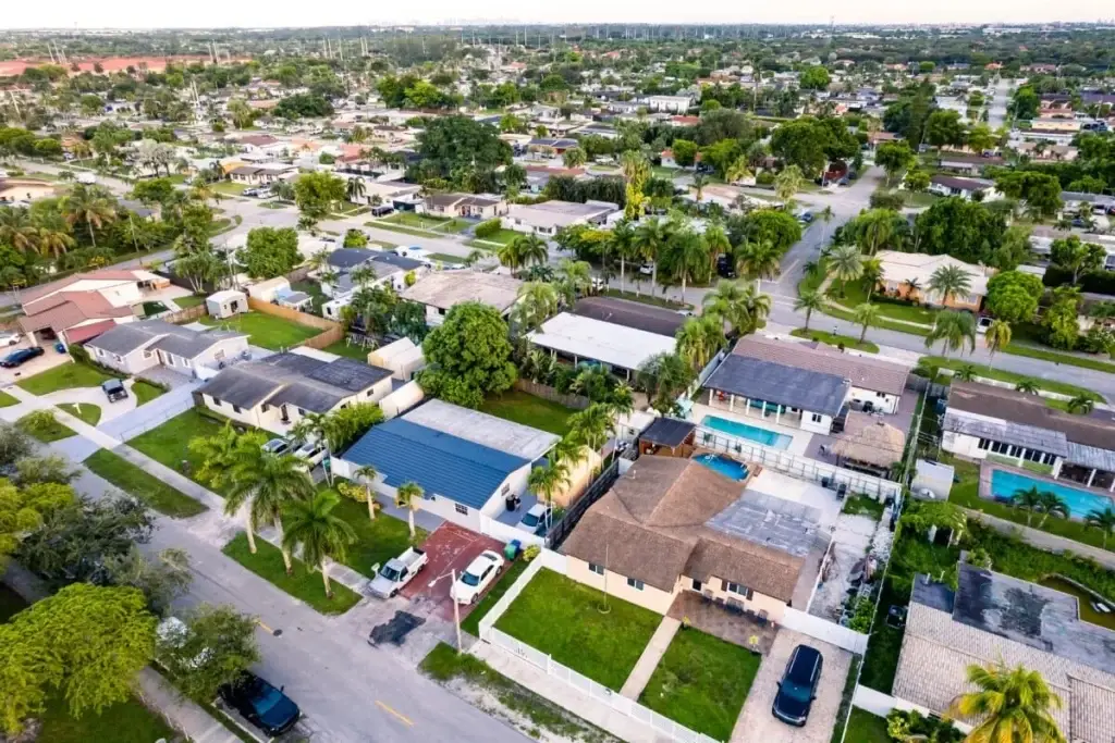 Aerial view of Hialeah, FL, showcasing a vibrant residential area, roads, and nearby retail spaces.
