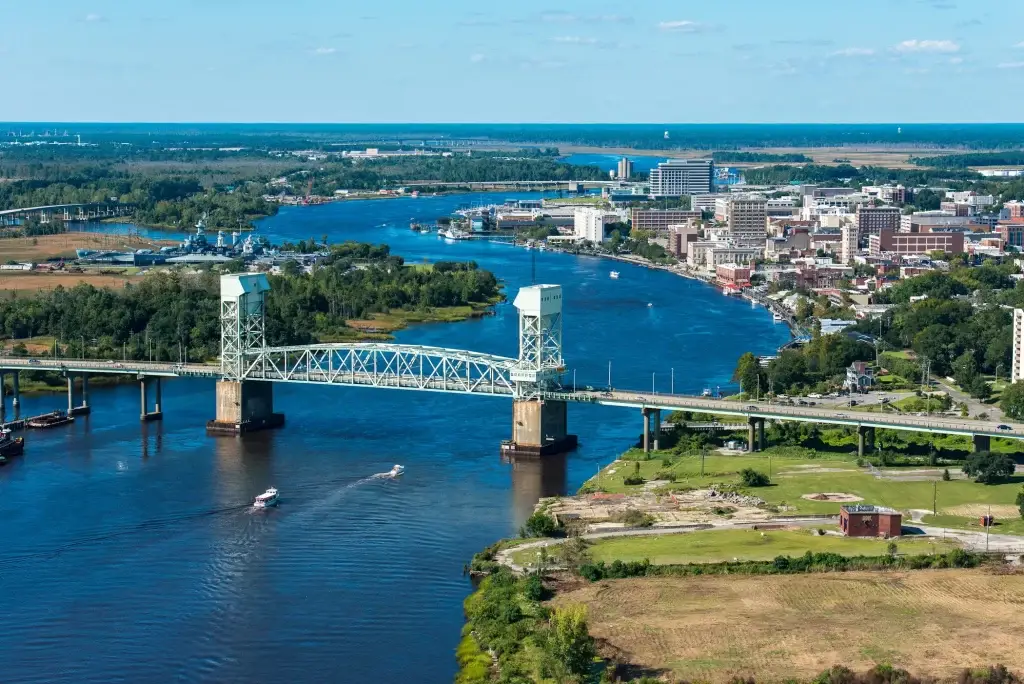 A stunning view of Wilmington’s skyline and Cape Fear River with the bridge, representing Website Design Wilmington NC.