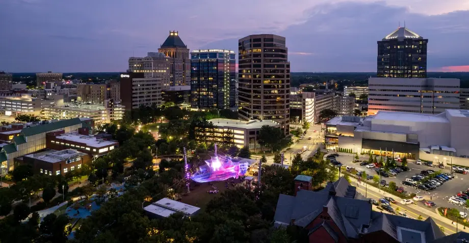 The Greensboro skyline lit up at night, showcasing the city's bustling energy, perfectly aligned with Website Design Greensboro NC.