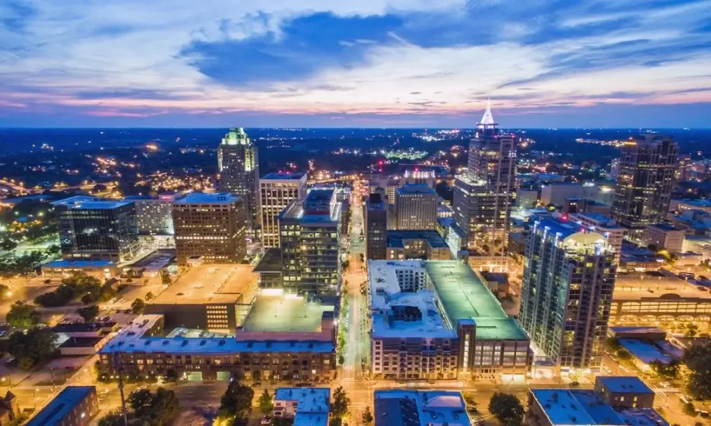 A beautiful night view of Raleigh’s city skyline, glowing lights illuminating the streets. Website Design Raleigh NC.