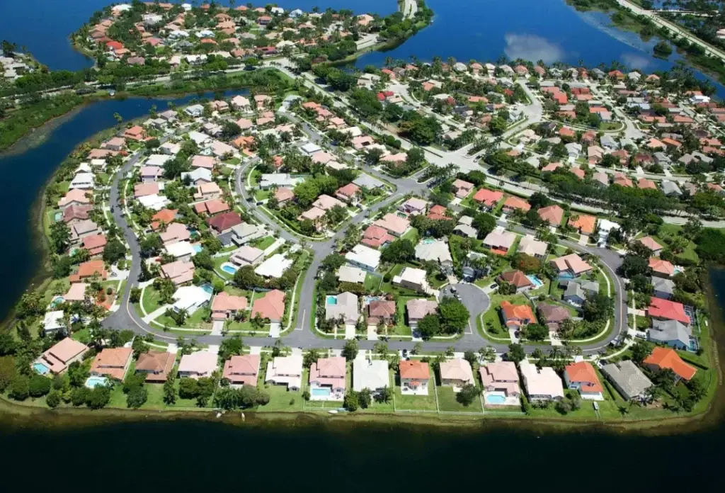 Aerial view showcasing the serene, suburban neighborhood in Pembroke Pines, FL, with homes and water features.