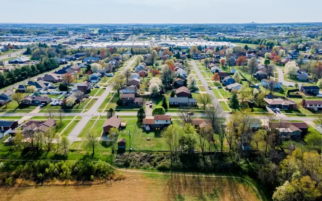 Residential area with rows of houses and blooming trees, showing the suburban market that requires professional Website Design Elizabethtown KY.