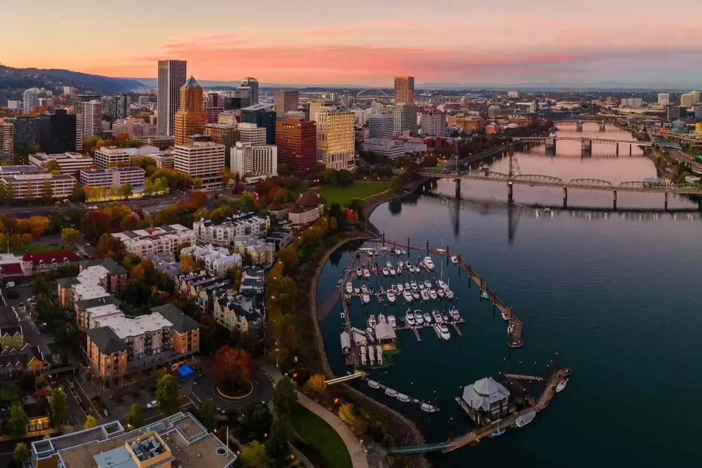 Portland waterfront & skyline at sunset, with marina & bridges. Businesses thrive with expert Website Design Portland OR.