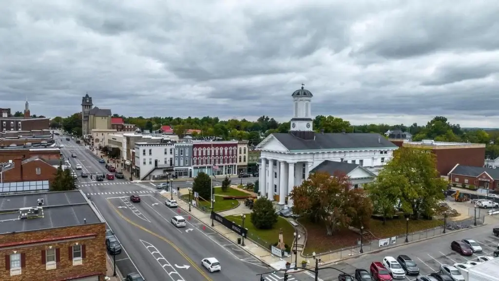 Drone perspective of the white, columned Madison County Courthouse nestled within the downtown area, home to many businesses needing Website Design Richmond KY.