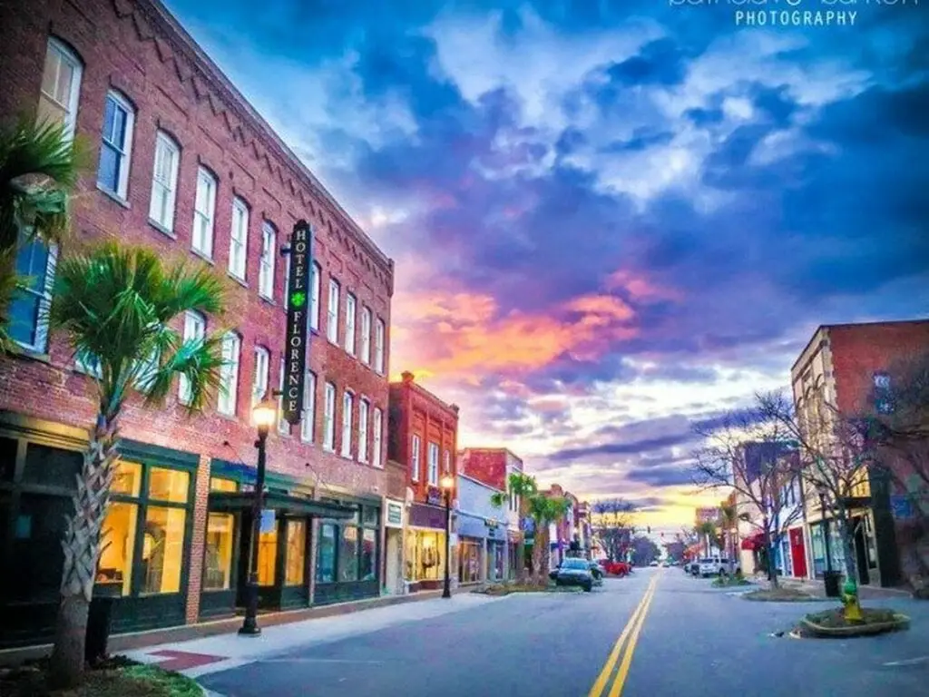 A vibrant street view of Florence SC with the Hotel Florence and beautiful sky, ideal for Website Design Florence SC.