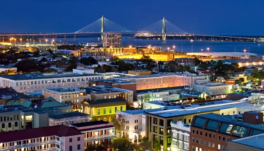 A view of downtown Charleston SC at night with the Arthur Ravenel Jr. Bridge in the background, showcasing city lights, highlighting Website Design Charleston SC.
