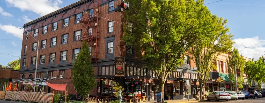 A street-level view of a historic brick building in downtown Corvallis with storefronts. Great Website Design Corvallis OR helps local shops.