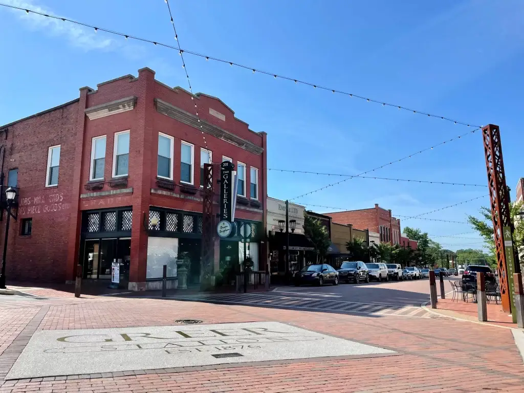 A vibrant view of downtown Greer SC with charming brick buildings and street lights, perfect for Website Design Greer SC.