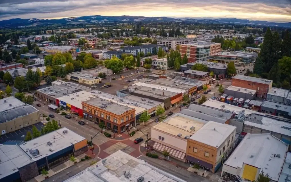 Aerial view of downtown Hillsboro's streets and buildings under a cloudy sky, a key area for Website Design Hillsboro OR.