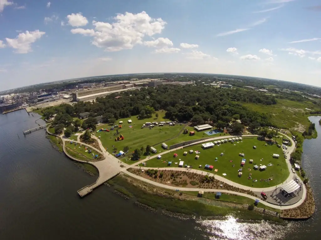 A stunning aerial view of Goose Creek SC's waterfront park with tents and green spaces, ideal for Website Design Goose Creek SC.