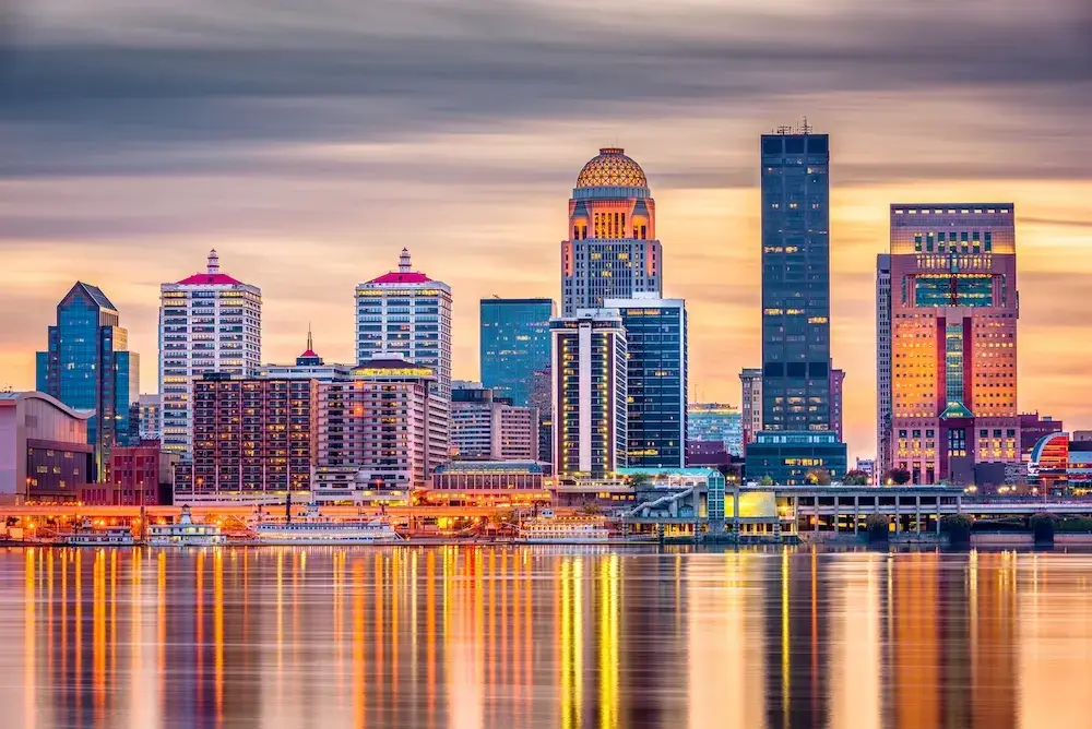 The Louisville skyline lit up at sunset, offering a stunning view of the city’s architecture, ideal for Website Design Louisville KY.