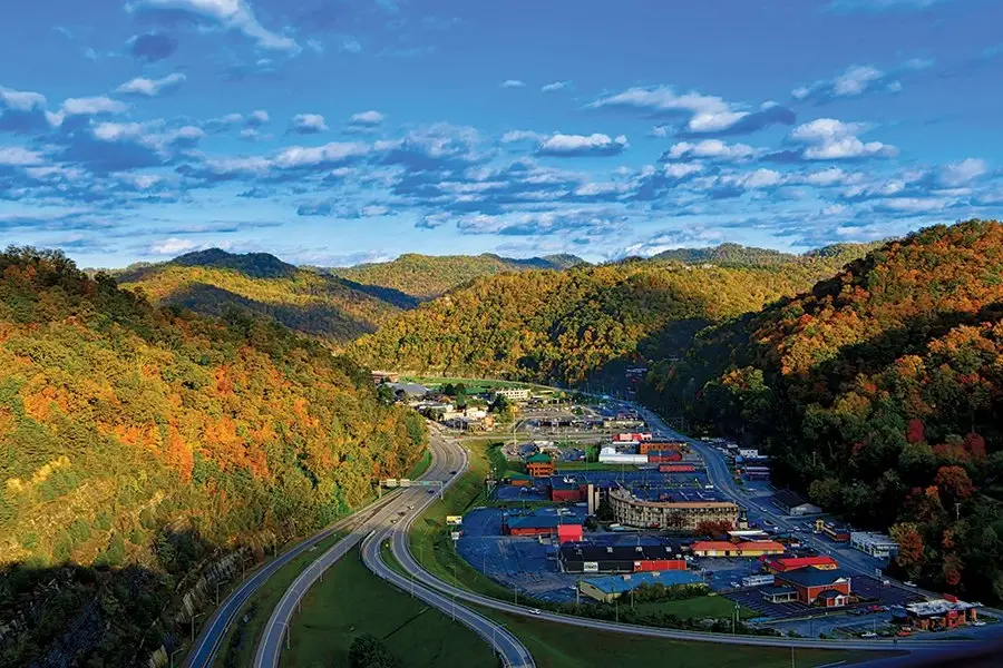 Dramatic view of the Pikeville Cut-Through highway and commercial area nestled in a colorful autumn mountain valley, a market for excellent Website Design Pikeville KY.