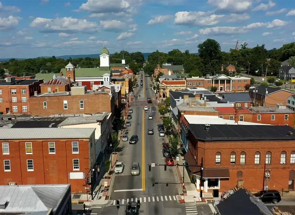 Aerial perspective of Somerset, KY's main street lined with brick commercial buildings leading to a clock tower, needing excellent Website Design Somerset KY.