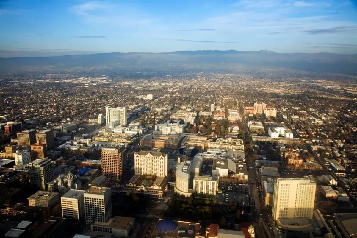 Aerial panorama of downtown buildings and mountains near Website Design San Jose CA