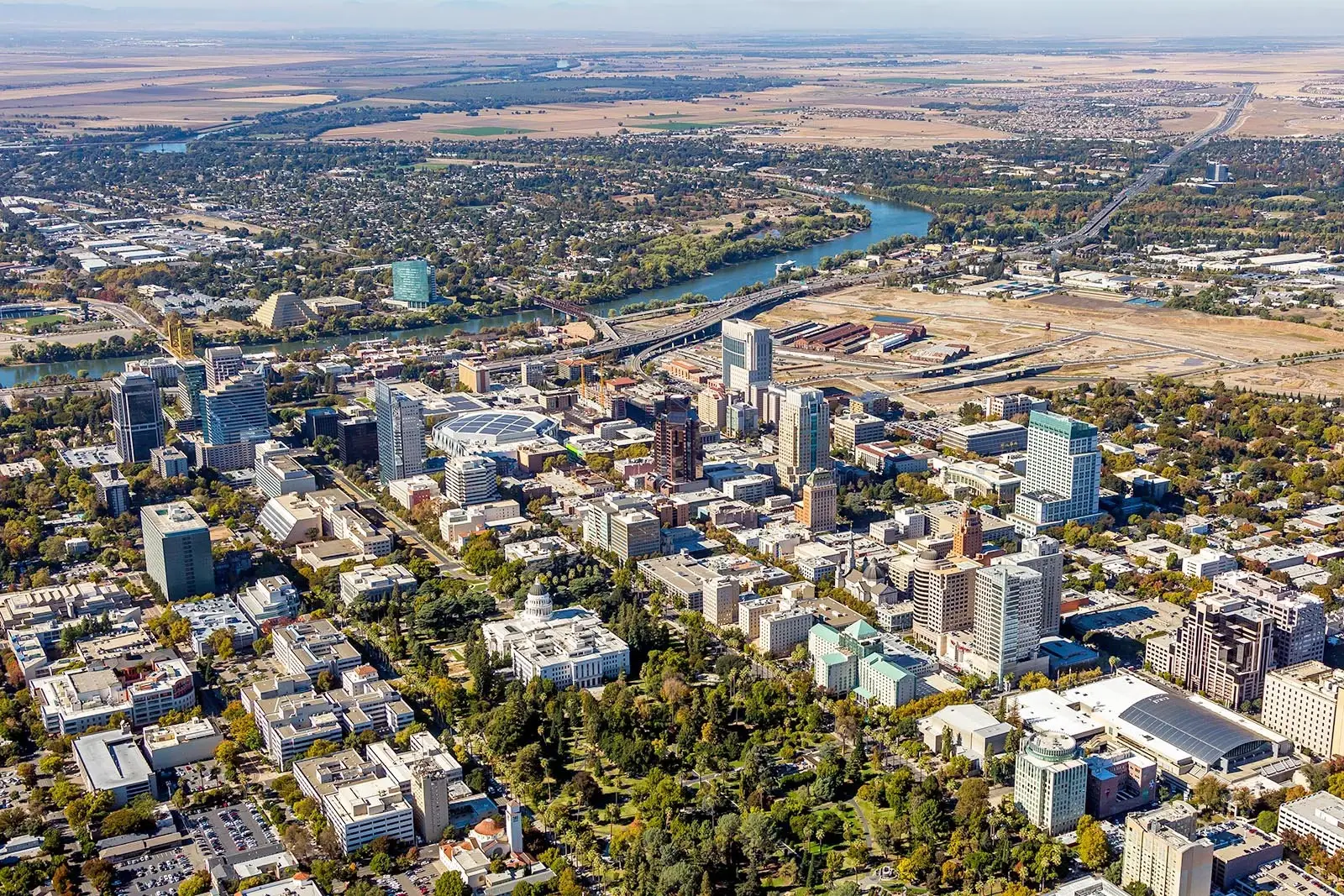 High-angle aerial view of the river and downtown streets near Website Design Sacramento CA