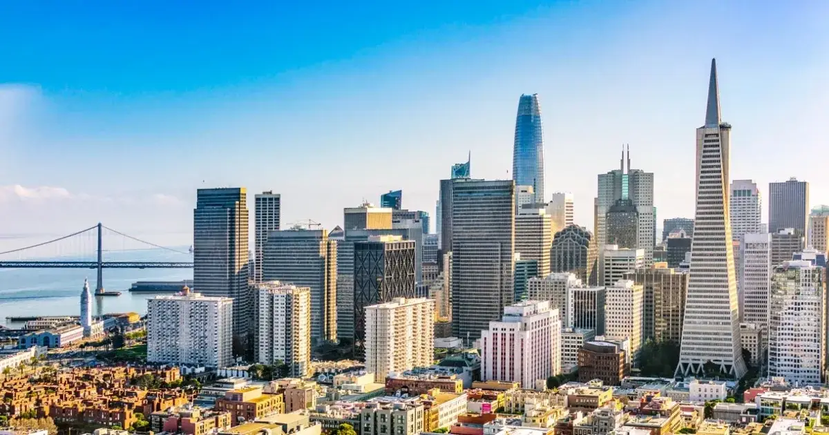 Colorful Victorian houses backed by the modern downtown skyline for Website Design San Francisco CA