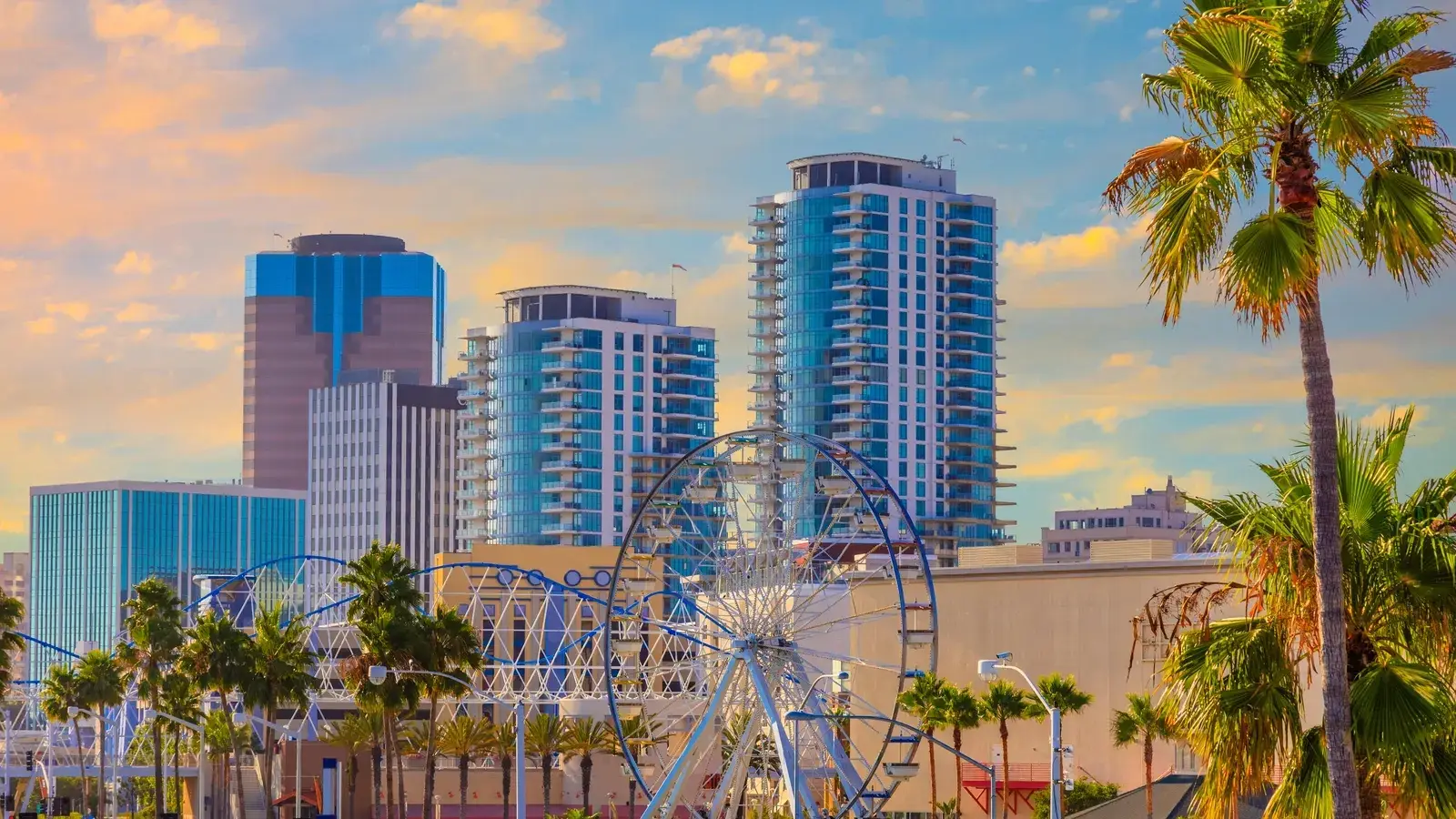 Sunny view of a Ferris wheel and modern high-rise buildings near Website Design Long Beach CA