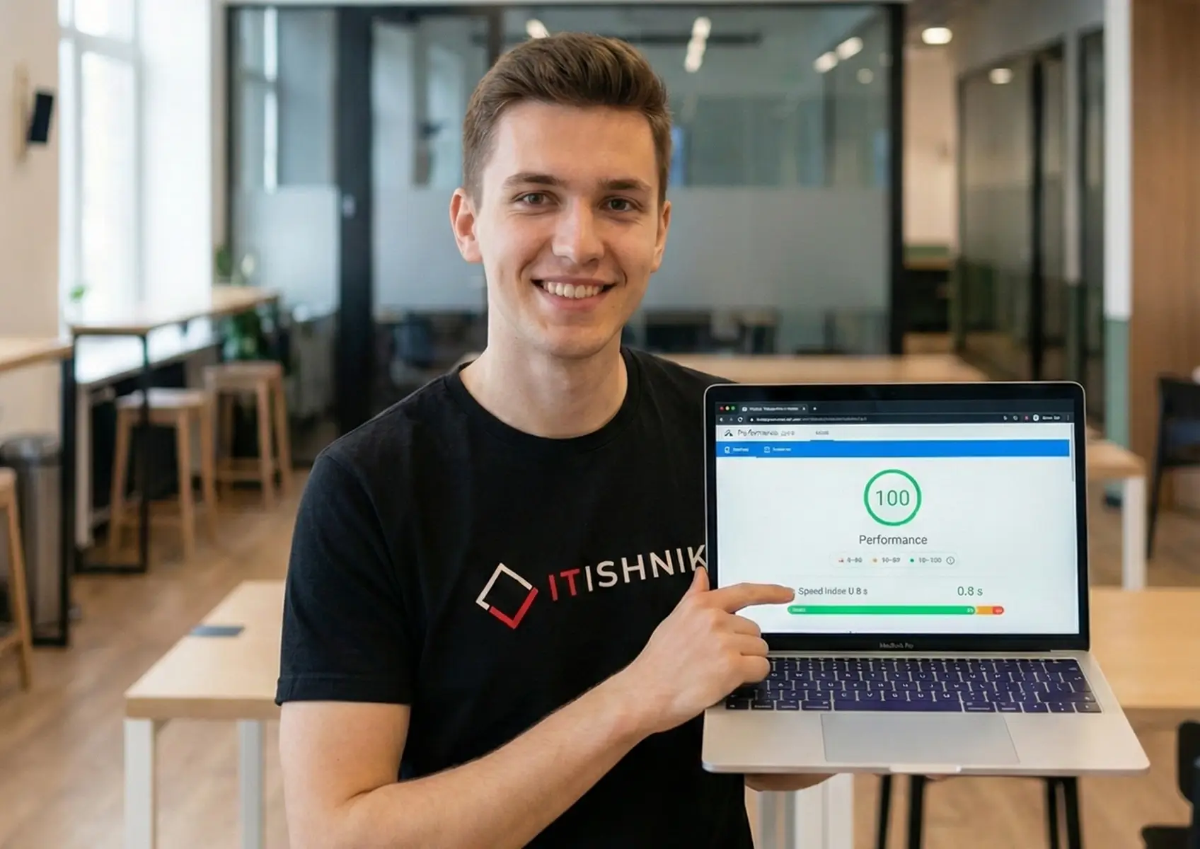 Smiling man holding a laptop showing a 100/100 speed score for an optimized Html website