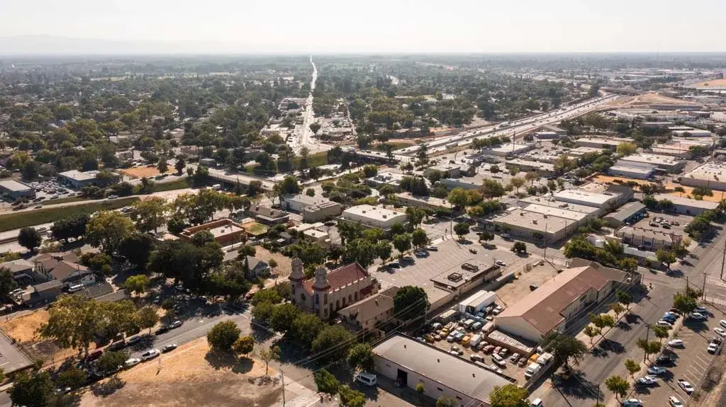 Commercial buildings and residential streets in Modesto under a clear sky served by Website Design Modesto CA.