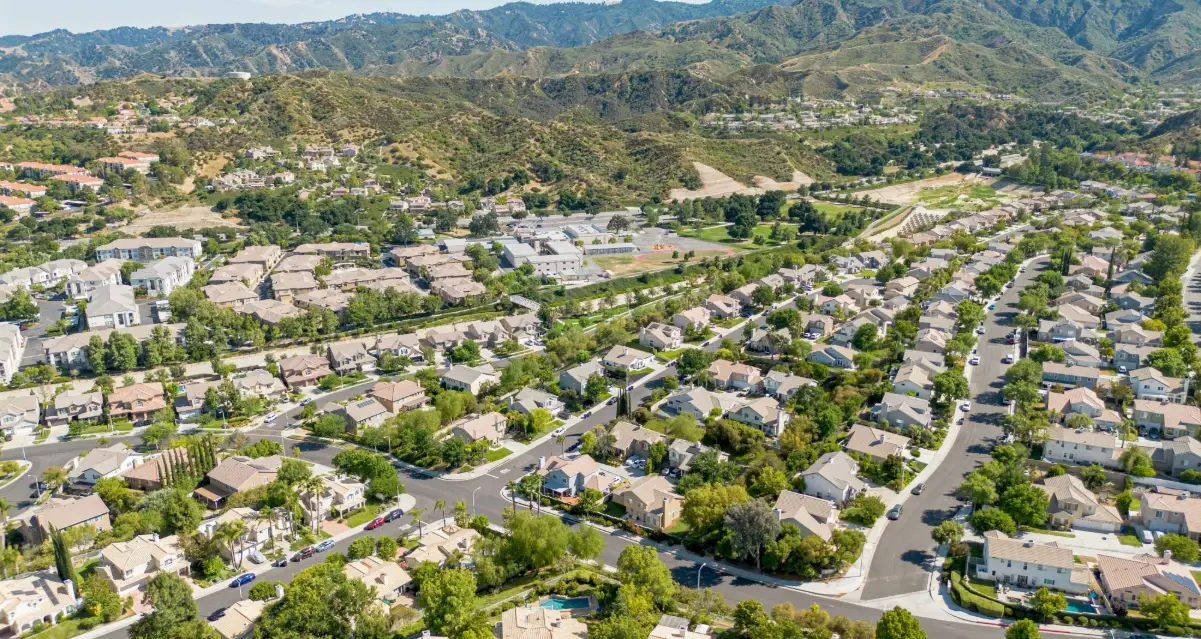 Aerial view of Santa Clarita suburban homes backed by green mountains near Website Design Santa Clarita CA experts.