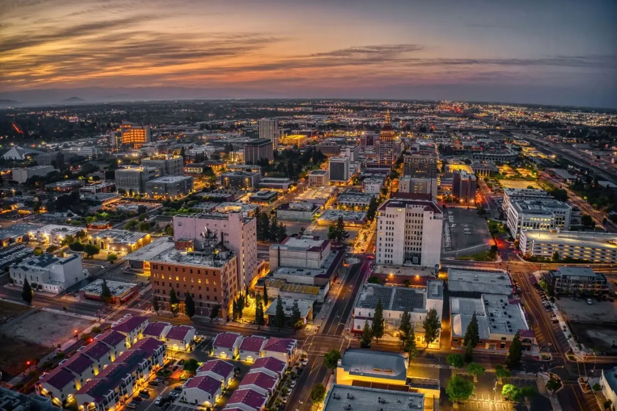Aerial view of illuminated city streets and buildings at dusk for Website Design Fresno CA